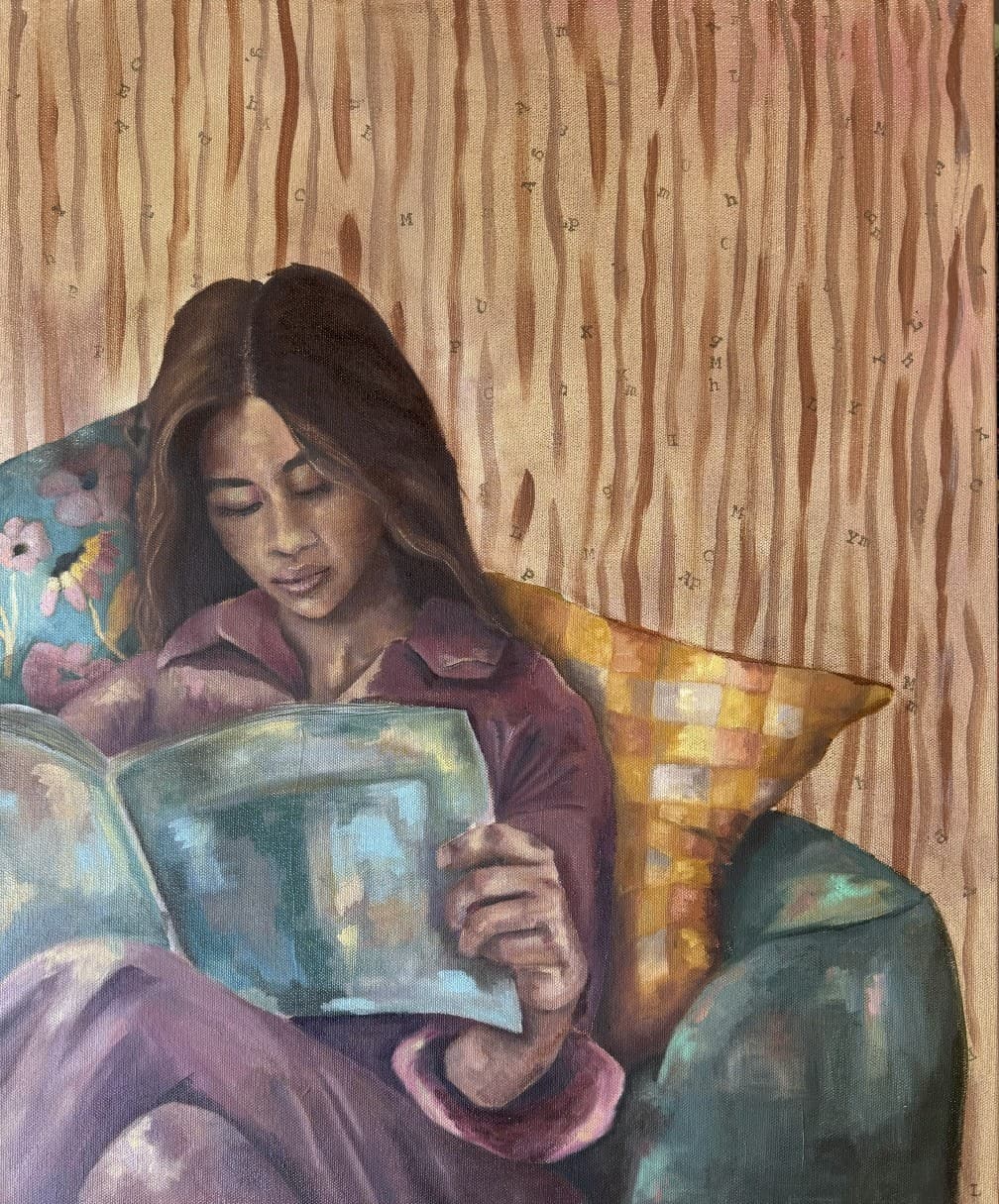 A woman in a mauve shirt reads a magazine on a teal armchair against a striped wall scattered with typewriter letters.